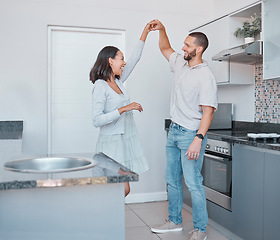 Image showing Romance, love and couple in the kitchen for a dance, happiness and smile in marriage. Quality time, happy and dancing man and woman with romantic energy to music in their apartment with care together
