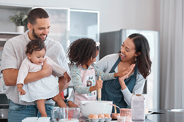 Image showing Family, baking and cooking together with high five in home kitchen with children learning from mother and father to cook food, breakfast and pancakes or cake. Man, woman and kids helping make cookies