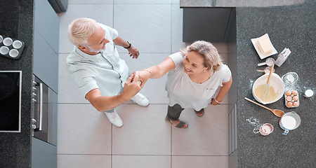 Image showing Top view dancing and senior couple in kitchen having fun, bonding and enjoy retirement together. Love, romance and aerial of happy elderly man and woman cooking, baking and dance on weekend at home