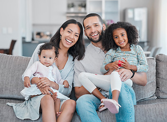 Image showing Happy, smile and portrait of a family on a sofa relaxing, bonding and sitting together in the living room. Mother, father and children resting on the couch with love, care and happiness at their home