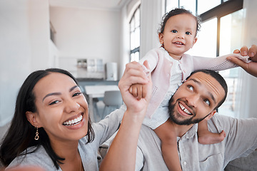 Image showing Family, portrait and playing with a mother, father and baby girl being playful and cheerful in the family home. Fun, funny and man and woman loving, caring and carrying little girl for comic bonding