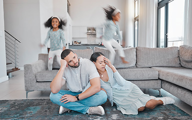 Image showing Tired, parents and children jump on sofa with frustrated mom and dad sitting on floor in living room. Family, exhausted couple and playful kids with energy jumping on couch at home during quarantine