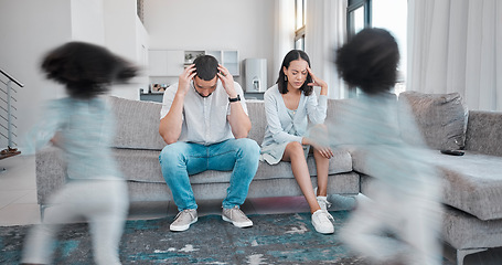 Image showing Mother, father and stress in burnout with child busy running around in the living room annoying parents on sofa at home. Tired mom and dad suffering in depression, anxiety or headache from noisy kids