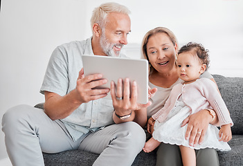 Image showing Grandparents, baby girl and tablet learning on living room sofa for online games, watching cartoons and relax at home. Happy family, grandmother and grandpa play with child on digital educational app