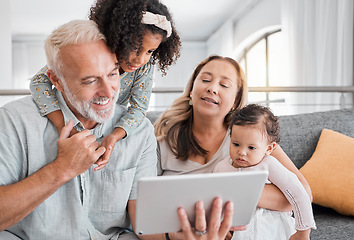 Image showing Relax, tablet and grandparents with children on sofa for movie, cartoon or educational app online. Grandmother, grandpa and kids streaming entertainment in interracial family home in Mexico.