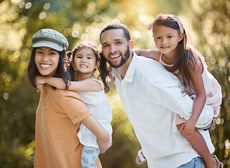 Image showing Family portrait, piggy back and love in park, happy smile and care together in nature park together in summer. Mother, father and girl kids, holiday and happiness with care, support or bond in forest