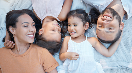 Image showing Happy family, love and care of parents for children lying on a blanket for bonding, quality time and support. Black man, woman and kids from top together on a picnic for fun, relax and portrait