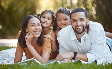 Image showing Family, portait and garden with a man and woman bonding with their little girl kids in summer. Nature, park and mother, father and daughter, sister and siblings relaxing on the grass for love bond