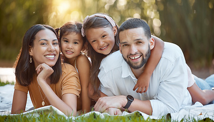 Image showing Portrait, picnic and family relax, smile and happy in nature park on blanket together in summer in brazil. Girl kids, mother and father laying on ground, support and happiness in forest with care