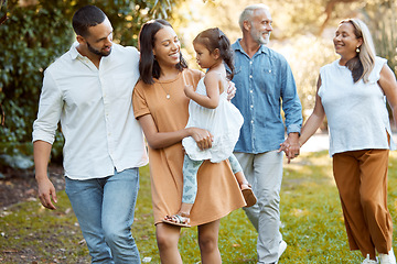 Image showing Family, walking and together in park with love and spending quality time outdoor, for bonding and care. Grandparents, parents and child walk, happy in nature and happy family generations.