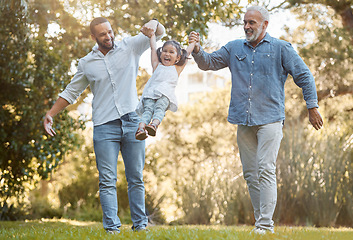 Image showing Diverse, family and playing in a park for fun, bonding and love in summer with a father, grandfather and daughter. Garden, big family and interracial family swinging little girl play with joy