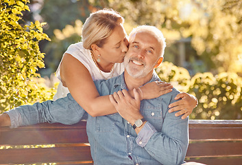 Image showing Love, relax and happy with old couple in park bench for retirement, support and affectionate. Bonding, kiss and hug with portrait of man and woman in countryside for smile, nature and marriage