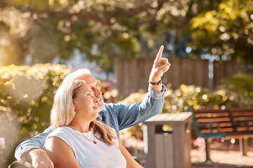 Image showing Mature, couple and man and woman bonding in the park enjoying the view while relaxing on a bench. Senior husband and wife bond in romantic relationship for a summer vacation with care and love