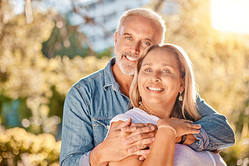 Image showing Mature couple, hug and bonding in nature park, environment garden or backyard for interracial marriage anniversary, love or trust. Portrait, smile or happy man and middle aged woman in retirement