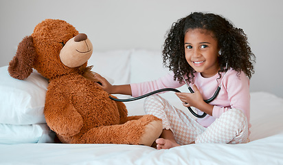 Image showing Learning, teddy bear and girl playing with stethoscope, having fun or acting like doctor in bedroom. Portrait, education and child test, check or listening to heartbeat of stuffed animal or baby toy.