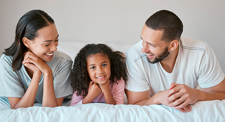 Image showing Family, portrait and home with a parents relax and resting with their little girl in the family home. Mother, father and daughter for caring, loving and bond relationship in the bedroom