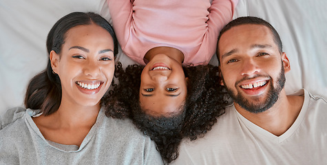 Image showing Love, bed and portrait of black family relax at home for peace, bonding and enjoy morning quality time together. Bedroom, smile and happy family face of African mother, father and kid girl top view