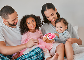 Image showing Happy family, love and bedroom with child, baby and parents together on a bed for care, bonding and quality time at home. Portrait of kids, man and woman in Puerto Rico house to relax and connect