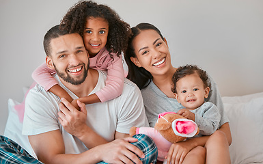 Image showing Bonding, care and smile from family in the bedroom with love, peace and relax together in the morning. Happy, affection and portrait of a mother and father with their girl children in bed for rest