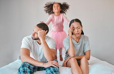 Image showing Stress, divorce and couple with a child on the bed with her parents in an argument or disagreement. Tired, break up and young angry mother and father with a adhd girl jumping in bedroom at their home