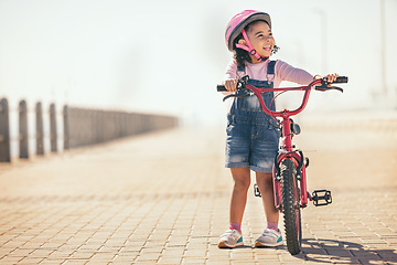 Image showing Fun, thinking and girl cycling with a bike in the city for sustainability, carbon footprint and eco friendly transport. Happy, smile and child with an idea and a bicycle in the street for happiness