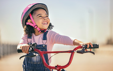 Image showing Thinking, eco friendly and girl cycling on a bike, learning and training in city with a smile. Playing, exercise and child on a bicycle for carbon footprint, sustainability and happy in the street