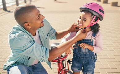 Image showing Father, child and safety helmet while outdoor with bicycle on the promenade for fun and quality time while learning to ride a bike. Man and girl family together for training and development in summer