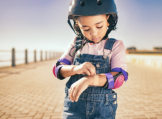 Image showing Cycling injury, arm bandage and child in street with bruise after fall or accident. First aid, bandaid and hurt city girl with safety helmet after playing, sports or fitness exercise alone on road.