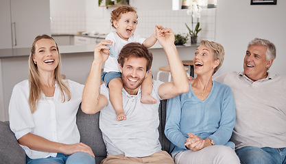 Image showing Playful, portrait and big family on the living room sofa during a visit from grandparents. Love, smile and baby bonding with his parents and senior man and woman on the couch in happiness together