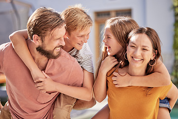 Image showing Happy family and kids piggy back in a garden with parents, happy and playful while bonding, laughing and enjoying fun. Family, kids and cheerful mother with dad in backyard for fun on the weekend