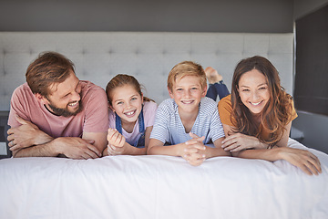 Image showing Happy, relax and portrait of a family on a bed for love, peace and calm in their house together. Smile, happiness and comfort for children with their mother and father in the bedroom of their home