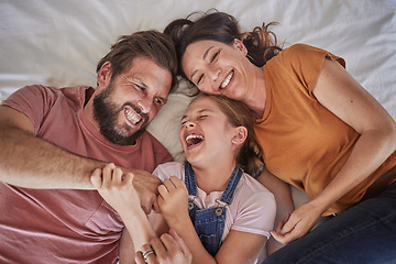 Image showing Family, bed and child with tickle, happy or comic play for quality time, bonding or home together. Above, parents and girl with happiness, laugh or crazy with love, mom and dad in happy family house