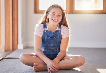 Image showing Portrait of happy girl, kid and child on living room floor, carpet and ground for fun, play and happiness alone. Excited youth, smile children and one female relax in lounge, house and family home