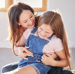 Image showing Happy, love and mother bonding with her child while playing, laughing and relaxing together at their home. Happiness, smile and woman being playful with her girl kid in their modern house in Canada.