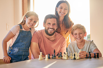 Image showing Chess, game and family playing, learning and teaching in the living room of their house together. Games, happy and portrait of parents with their children and a board game competition in their home