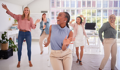 Image showing Business, women and group dance for fun celebration in a creative office for campaign success with diverse staff. Joy, excitement and dancing with a multicultural team of ladies celebrating