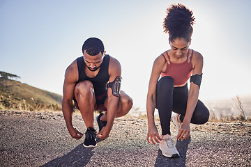 Image showing Fitness couple, running shoes and exercise on a road outdoor for cardio workout and training together for health and wellness. Black woman and man tying shoelace or sneakers for a agile run