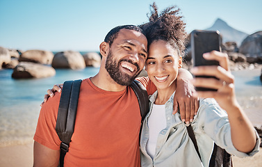 Image showing Couple, phone selfie and beach travel adventure together for social media, holiday vacation and summer in nature. Man, happy woman and hug for mobile phone photograph at ocean sea for happiness