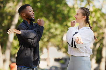 Image showing Interracial, couple and stretching for wellness, training and exercise for workout and bonding in park. Healthy, man and woman outdoor for fitness, practice and together to relax, health and speaking