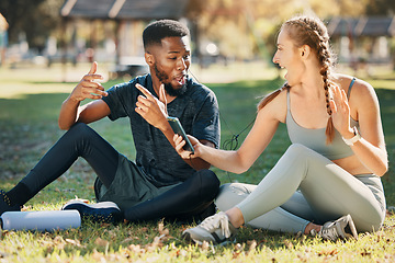 Image showing Music, phone and earphone couple in park on fitness run break rap, singing and listen together. Streaming, tech and interracial people listening to feel good beats with mobile app to relax.