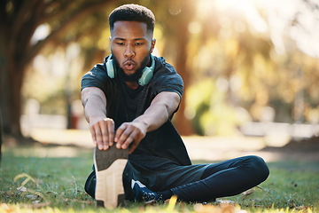 Image showing Health, black man and stretching outdoor for exercise, fitness or wellness with breathing and focus. Healthy male, athlete or training for workout, balance or endurance for cardio, stamina on grass