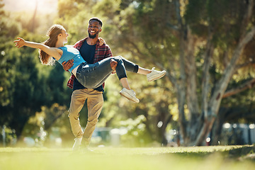 Image showing Crazy couple, carry and happy smile, fun and enjoy date in nature park, romance and care while running together. Interracial man, woman and love with happiness, freedom and energy in garden or forest