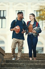 Image showing Black man, woman or university students walking and talking on college, school or education learning campus. Smile, happy or interracial couple or bonding friends on steps and football or study books