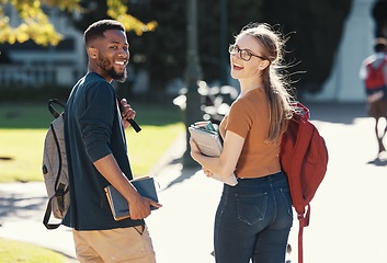 Image showing Friends, students or college couple walking with books and backpack on campus for education, learning and scholarship. Portrait of interracial man and woman at university or school to study and learn