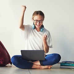 Image showing Education, woman student with laptop and celebrate university exam results, college scholarship news and learning success. Smart girl, study on floor and fist pump school test report with happy smile