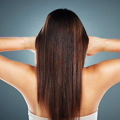 Image showing Beauty, salon and wellness model with straight hair texture from smooth, healthy and brazilian keratin shampoo. Cosmetic, shine and beautiful hair care woman in gray studio with back view.