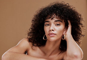 Image showing Beauty, natural hair and skincare with woman, hair care and wellness cosmetics portrait against brown studio background. Healthy skin, makeup and glow with clean cosmetic mockup and curly hair.