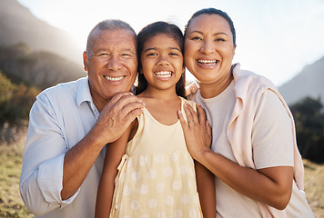 Image showing Happy, portrait and grandparents with girl in nature for family, relax or support. Embrace, bonding and summer with old man and woman smile with grandchild for affection, hug or youth in countryside