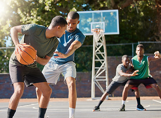 Image showing Basketball, sports and competition with a black man athlete playing a game on a court with friends or a rival. Team, fitness and health with a male basketball player training on a basketball court