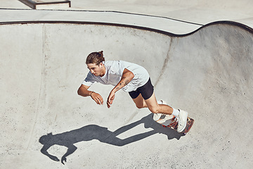 Image showing Skateboard, ramp and man skating at a park for exercise or practice at an urban city in Canada. Fitness, adventure and athlete skater doing skateboarding trick while training for a sports competition